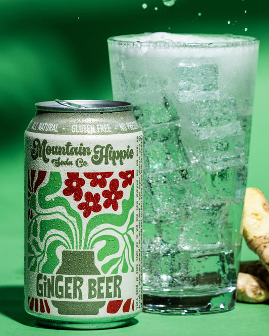 Mountain Hippie Soda Co. Ginger Beer with cup of ice with Ginger Beer can next to cup