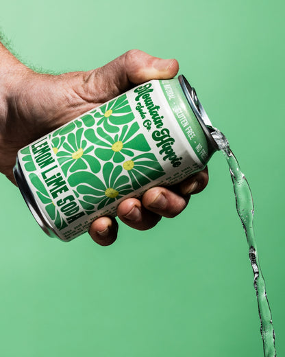 Mountain Hippie Soda Co. Lemon Lime Soda being poured from the can